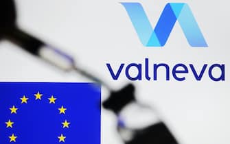 In this photo illustration a Valneva logo and the EU flag are seen in front of a vial and a medical syringe. (Photo by Pavlo Gonchar / SOPA Images/Sipa USA)