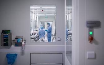 Employees in protective gear work at the aseptic filling section at the facility of pharmaceutical company AstraZeneca for biological medicines in Södertälje, south of Stockholm, Sweden on February 8, 2022. - AstraZenecas new facility in Sweden located in Södertälje was inaugurated last December and is dedicated to the production of next generation biological drugs such as Evusheld, a Covid-19 preventative monoclonal antibody treatment for immunocompromised people.  (Photo by Jonathan NACKSTRAND / AFP) (Photo by JONATHAN NACKSTRAND/AFP via Getty Images)