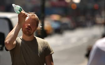 NEW YORK - JUNE 9:  A man tries to cool himself with a bottle of water during the first heat wave of the year June 9, 2008 in New York City. According to the National Weather Service temperatures will near 100 degrees today in the New York metro area with no relief in sight until Wednesday, June 11.  (Photo by Spencer Platt/Getty Images)