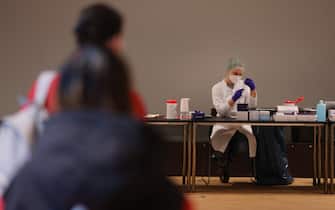 BERLIN, GERMANY - JANUARY 18: A medical assistant prepares syringes with the Pfizer/BioNTech vaccine against Covid-19 as people wait for their inoculations at the Humboldt Forum museum during the Omicron wave of the coronavirus pandemic on January 18, 2022 in Berlin, Germany. The museum has launched a three-day vaccination drive for anyone in Berlin seeking a shot. Approximately 73% of the population in Germany is now fully vaccinated. Meanwhile Omicron has fuelled record-breaking rates of new infections since the beginning of the year.  (Photo by Sean Gallup/Getty Images)