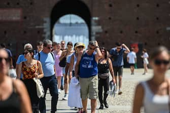 Tourists walk in Sforzesco castle in Milan, on July 22, 2022 amid a fierce heatwave which sweeps Europe. (Photo by Piero CRUCIATTI / AFP) (Photo by PIERO CRUCIATTI/AFP via Getty Images)