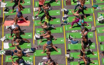 Thousands of yoga practitioners pack Times Square in New York to practice yoga on the first day of summer, Thursday, June 21, 2018. The 16th annual Solstice in Times Square, "Mind Over Madness", sponsored by American Eagle Outfitters' athleisure brand Aerie, stretches the yogis' ability to block out the noise and the visual clutter that surround them in the Crossroads of the World. The first day of summer has been declared the International Day of Yoga by the United Nations. (ÂPhoto by Richard B. Levine)