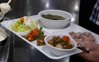 epa08432985 A man wearing a glove takes food at the cafeteria of Seoul city hall in Seoul, South Korea, 20 May 2020. Countries around the world are taking increased measures to stem the widespread of the SARS-CoV-2 coronavirus which causes the Covid-19 disease.  EPA/JEON HEON-KYUN