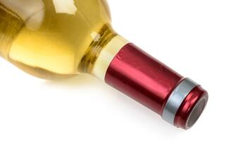 Lying white wine bottle close up. Bottleneck isolated on white background