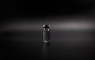 Small vaccine bottle (phial) isolated on black background Vaccination for prevention, immunization and treatment to virus and bacteria infections