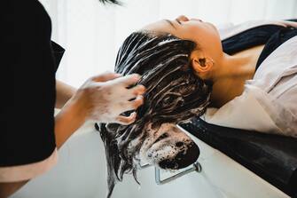 asian woman has her hair washed at a hair saloon