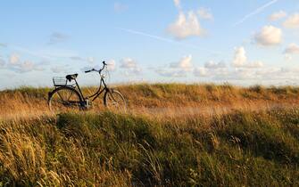 Bicycle on a coastal boardwalk against a beautiful blue sky, 
North Sea Islands of Germany, Wangerooge.