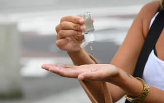 NEW YORK, NEW YORK - SEPTEMBER 07: A person uses a hand sanitizer during Phase 4 of re-opening following restrictions imposed to slow the spread of coronavirus on September 7, 2020 in New York City. The fourth phase allows outdoor arts and entertainment, sporting events without fans and media production. (Photo by Noam Galai/Getty Images)