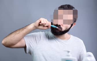 Man with Beard Washing His Teeth with a Toothbrush