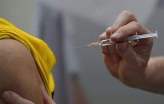 A flu vaccination is injected on the arm of a person during a press event to promote flu vaccinations in Berlin on October 29, 2019. (Photo by Tobias SCHWARZ / AFP) (Photo by TOBIAS SCHWARZ/AFP via Getty Images)