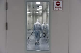 Employees wearing protective equipment walk in a passage at the headquarters of Russia's biotech company BIOCAD, which is developing its own vaccine against the new coronavirus and working on another one in cooperation with the country's virus research centre in Siberia, Vektor, in Strelna on May 20, 2020. (Photo by OLGA MALTSEVA / AFP) (Photo by OLGA MALTSEVA/AFP via Getty Images)