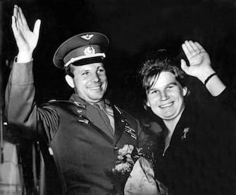 MOSCOW, RUSSIA:  Soviet cosmonaut Yuri Gagarin, 29, (1934-68) and cosmonaut Valentina Tereshkova, the first woman to fly in space, wave to well-wishers somewhere in Soviet Union in 1963. Gagarin became in 1961 the first man to travel in space, orbiting Earth, Tereshkova was the sole crew member of the 3-day Vostok 6 spaceship flight 16 June 1963. (Photo credit should read AFP via Getty Images)