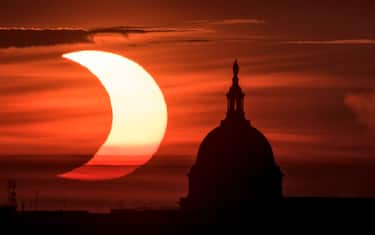 epa09259307 A handout picture made available by the National Aeronautics and Space Administration (NASA) shows a partial solar eclipse as the sun rises to the left of the United States Capitol Building, 10 June 2021, as seen from Arlington, Virginia. The annular or  ring of fire  solar eclipse is only visible to some people in Greenland, Northern Russia, and Canada.  EPA/NASA HANDOUT / Bill Ingalls  HANDOUT EDITORIAL USE ONLY/NO SALES