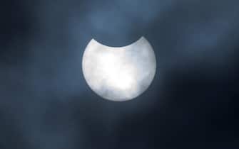 A partial solar eclipse as seen over Canary Wharf in London. Picture date: Thursday June 10, 2021.