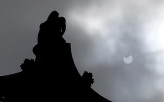 The top of Nelson's Column is silhouetted against the sky during a partial solar eclipse as seen over Trafalgar Square, London. The annular eclipse occurs when the sun and moon are exactly in line with the Earth, but the apparent size of the moon is smaller than that of the sun, causing the sun to appear as a very bright ring, or annulus. Picture date: Thursday June 10, 2021.