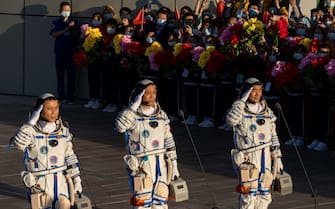 CHINA SPACE PROGRAMS SHENZHOU12 epa09278425 Chinese astronauts (L-R) Tang Hongbo, Nie Haisheng, and Liu Boming salute during a departure ceremony before the launch of the Long March-2F carrier rocket, carrying the Shenzhou-12 at the Jiuquan Satellite Launch Center, in the Gobi Desert, northwest of China, 17 June 2021. China launches Shenzhou-12 spacecraft carrying three crew members Tang Hongbo, Nie Haisheng, and Liu Boming to the orbiting Tianhe core module for a three-month mission on 17 June. It is the first spaceflight in almost five years where China sends humans into space. EPA/ROMAN PILIPEY