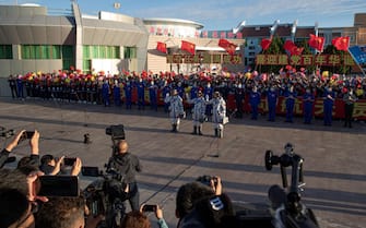 CHINA SPACE PROGRAMS SHENZHOU12 epa09278432 Chinese astronauts Tang Hongbo, Nie Haisheng, and Liu Boming wave during a departure ceremony before the launch of the Long March-2F carrier rocket, carrying the Shenzhou-12 at the Jiuquan Satellite Launch Center, in the Gobi Desert, northwest of China, 17 June 2021. China launches Shenzhou-12 spacecraft carrying three crew members Tang Hongbo, Nie Haisheng, and Liu Boming to the orbiting Tianhe core module for a three-month mission on 17 June. It is the first spaceflight in almost five years where China sends humans into space. EPA/ROMAN PILIPEY
