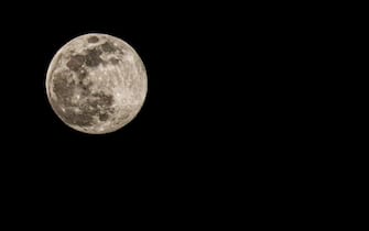 Largest full moon of the year - The perfect shaped moon called Supermoon is seen in the night sky of Calvi, CORSICA, FRANCE on April 7, 2020. La plus grande super lune de 2020, bien qu'elle soit appelée la Super Lune Rose, There is a difference between 7 and 9 April 2020. Ici in Calvi en Corse.  7 April 2020