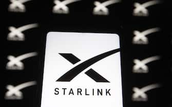 UKRAINE - 2021/02/21: In this photo illustration a Starlink logo of a satellite internet constellation being constructed by SpaceX is seen on a smartphone and a pc screen ,.  (Photo Illustration by Pavlo Gonchar / SOPA Images / LightRocket via Getty Images)
