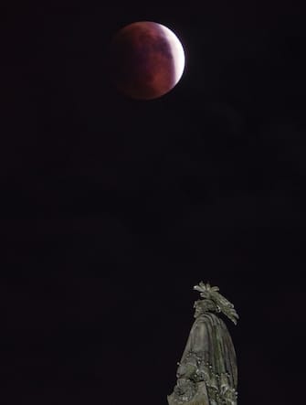 UNITED STATES - MAY 16: The Super Flower Blood Moon lunar eclipse appears over the Statue of Freedom atop the US Capitol dome in Washington on Sunday, May 16, 2022 .. (Bill Clark / CQ-Roll Call, Inc via Getty Images).
