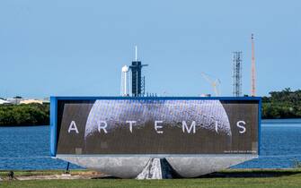 Launch Pad Complex 39B is seen behind a screen displaying NASA's Artemis I Moon logo at Kennedy Space Center, in Cape Canaveral, Florida, on August 16, 2022. - Artemis 1, an uncrewed test flight, will feature the first blastoff of the massive Space Launch System (SLS) rocket, which will be the most powerful in the world when it goes into operation. It will propel the Orion crew capsule into orbit around the Moon. The spacecraft will remain in space for 42 days before returning to Earth. (Photo by CHANDAN KHANNA / AFP) (Photo by CHANDAN KHANNA/AFP via Getty Images)