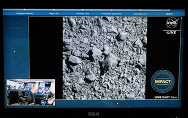 A television at NASA's Kennedy Space Center in Cape Canaveral, Florida, captures the final images from the Double Asteroid Redirection Test (DART) as it smashes into the asteroid Dimorphos on September 26, 2022. - NASA's DART spaceship on September 26 struck the moonlet asteroid Dimorphos, in a historic test of humanity's ability to prevent a cosmic object devastating life on Earth. (Photo by Jim WATSON / AFP) (Photo by JIM WATSON/AFP via Getty Images)