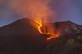 CATANIA, ITALY - May 16: A photo shows a new eruption at Volcano Etna, from Valley of the Ox in the territory of Milo, near Catania, Italy on May 16, 2022. The new phase of eruptive activity started in the late evening of May 12 . The lava emerging from the new eruptive fissure on the northern flank of the Southeast crater continues to keep the flow active, while ash columns, steam and strombolian explosions alternate from a new vent opened just below the northern rim of the Sud-Est crater. (Photo by Salvatore Allegra/Anadolu Agency via Getty Images)
