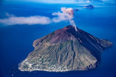 STROMBOLI, ITALY - JUNE 06: Aerial view, from a helicopter, of the Stromboli volcano, one of the most active volcanoes in the world, during an explosion with gas and ash emission.  It is 926 m high and reaches a depth of between 1300 m and 2400 m below sea level. The island is part of the Aeolian Islands archipelago in the province of Messina in northern Sicily on June 06, 2019 in Stromboli, Italy. Italy's nearly 8000 km (5,000 miles) coastlines and islands stretch across the Mediterranean Sea and attract large numbers of both local and foreign tourists during the summer season. (Photo by Fabrizio Villa/Getty Images)