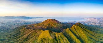 Aerial view of sunrise over majestic Mount Vesuvius volcano and Naples in summer, aerial view, Naples, Campania, Italy