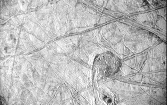 Surface features of Jupiter’s icy moon Europa have been revealed in an image obtained by Juno’s Stellar Reference Unit (SRU) during the spacecraft’s Sept. 29, 2022, flyby.
Observations from the spacecraft’s pass of the moon provided the first close-up in over two decades of this ocean world, resulting in remarkable imagery and unique science.
It is the highest-resolution photo NASA’s Juno mission has ever taken of a specific portion of Europa and reveals a detailed view of a puzzling region of the moon’s heavily fractured icy crust.
The image covers about 93 miles (150 kilometers) by 125 miles (200 kilometers) of Europa’s surface, revealing a region crisscrossed with a network of fine grooves and double ridges (pairs of long parallel lines indicating elevated features in the ice). Near the upper right of the image, as well as just to the right and below center, are dark stains possibly linked to something from below erupting onto the surface. Below center and to the right is a surface feature that recalls a musical quarter note, measuring 42 miles (67 kilometers) north-south by 23 miles (37 kilometers) east-west. The white dots in the image are signatures of penetrating high-energy particles from the severe radiation environment around the moon. 
Juno’s Stellar Reference Unit (SRU) – a star camera used to orient the spacecraft – obtained the black-and-white image during the spacecraft’s flyby of Europa on Sept. 29, 2022, at a distance of about 256 miles (412 kilometers). With a resolution that ranges from 840 to 1,115 feet (256 to 340 meters) per pixel, the image was captured as Juno raced past at about 15 miles per second (24 kilometers per second) over a part of the surface that was in nighttime, dimly lit by “Jupiter shine” – sunlight reflecting off Jupiter’s cloud tops.
Designed for low-light conditions, the SRU has also proven itself a valuable science tool, discovering shallow lightning in Jupiter’s atmosphere, imaging Jupiter’s enigmatic ring system, and now providing a glimpse of some of Europa’s most fascinating geologic formations.

-PICTURED: Jupiter`s Icy Moon
-LOCATION: United States USA
-DATE: 6 Oct 2022
-CREDIT: NASA/JPL-Caltech/SwR/Cover Images/INSTARimages.com