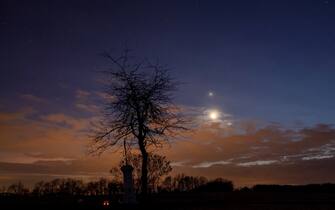 epa10484258 Planet Jupiter, the Moon (C) and planet Venus (R) observed on the sky photographed near Salgotarjan, Hungary, late 22 February 2023.  EPA/Peter Komka HUNGARY OUT