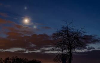 epa10484261 Planet Jupiter, the Moon (C) and planet Venus (R) observed on the sky photographed near Salgotarjan, Hungary, late 22 February 2023.  EPA/Peter Komka HUNGARY OUT