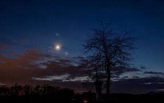 epa10484259 Planet Jupiter, the Moon (C) and planet Venus (R) observed on the sky photographed near Salgotarjan, Hungary, late 22 February 2023.  EPA/Peter Komka HUNGARY OUT