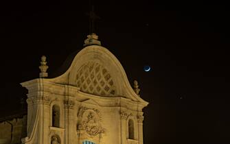 Venus and Jupiter planets in conjunction with a crescent moon rise behind Santa Maria del Suffragio (Holy souls church) in LAquila (Italy) on february 22, 2023.  (Photo by Lorenzo Di Cola/NurPhoto via Getty Images)