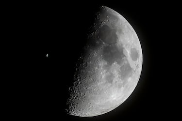 epa10550003 The International Space Station (ISS) passes in front of the Moon as captured near Buzitka, southern Slovakia, 29 March 2023 (issued 30 March 2023).  EPA/Peter Komka HUNGARY OUT