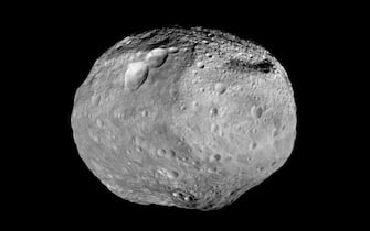 epa03889934 An undated handout photo made available by NASA on 30 September 2013, and made by NASA's Dawn spacecraft, showing a mosaic view of the giant asteroid Vesta.  The towering mountain at the south pole - more than twice the height of Mount Everest - is visible at the bottom of the image.  The set of three craters known as the 'snowman' can be seen at the top left.  Dawn studied Vesta from July 2011 to September 2012. Dawn will continue its cruise to its second destination, Ceres.  EPA / NASA / JPL-Caltech / UCAL / MPS / DLR / IDA / HANDOUT HANDOUT EDITORIAL USE ONLY