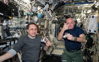 IN SPACE - APRIL 20:  In this handout photo provided by NASA, NASA astronaut Scott Kelly gives a thumbs up on the quality of his snack while taking a break from his work schedule aboard the International Space Station on April 20, 2015 in space. He and Russian cosmonaut Mikhail Kornienko (ROSCOSMOS) are eating specially prepared space food. (Photo by NASA via Getty Images)
