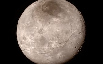 480799638 IN SPACE - JULY 13: In this handout provided by the National Aeronautics and Space Administration (NASA), Pluto's largest moon Charon is shown from a distance of 289,000 miles (466,000 kilometers) from the Long Range Reconnaissance Imager (LORRI) aboard NASA's New Horizons spacecraft, taken on July 13, and released July 15, 2015. New Horizons passed by Pluto July 14, closing to a distance of about 7,800 miles (12,500 kilometers). The image was combined with color information taken from the craft's Ralph instrument. The 1,050-pound piano sized probe was launched January 19, 2006 aboard an Atlas V rocket from Cape Canaveral, Florida, (Photo by NASA/APL/SwRI via Getty Images)