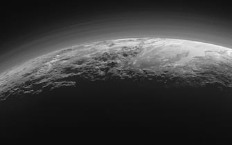 (FILE) SPACE PLUTO DEMOTION ANNIVERSARY epa06940541 (FILE) - A handout picture made available by NASA on 18 September 2015 and taken by the National Aeronautics and Space Administration's (NASA) New Horizons spacecraft shows a near-sunset view of the rugged, icy mountains and flat ice plains extending to Pluto's horizon, 14 July 2015. The image was taken from a distance of about 18,000 kilometers to Pluto, with a scene of 1,250 kilometers wide. Discovered on 18 February 1930 and for a long time considered the ninth and most distant planet to the sun in our solar system, it was reclassified as a 'dwarf planet' by the International Astronomical Union (IAU) on 24 August 2006 after another dwarft planet with a 27 percent bigger mass than Pluto was discovered in the so-called Kuiper belt beyond the planet Neptune. EPA/NASA/JHUAPL/SwRI/HANDOUT MANDATORY CREDIT: NASA/JHUAPL/SwRI HANDOUT EDITORIAL USE ONLY *** Local Caption *** 52653960
