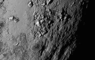 480799068 IN SPACE - JULY 14: In this handout provided by the National Aeronautics and Space Administration (NASA), a close-up image of a region near Pluto's equator shows a range of mountains rising as high as 11,000 feet (3,500 meters) taken by NASA's New Horizons spacecraft as it passed within 7,800 feet of the dwarf planet on July 14, 2015. The 1,050-pound piano sized probe, which was launched January 19, 2006 aboard an Atlas V rocket from Cape Canaveral, Florida, zipped by the planet yesterday. (Photo by NASA/APL/SwRI via Getty Images)