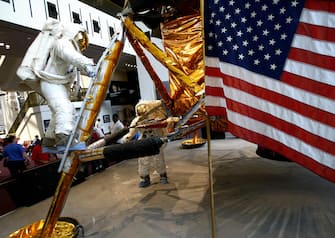 Visitors look at a model of the Apollo 11 Lunar Module at the Smithsonian's National Air and Space Museum 15 July 2003 in Washington, DC. 16 July marks the 34th anniversary of the Apollo 11 launch that took astronauts Neil Armstrong, Michael Collins and Buzz Aldrin to the moon in 1969.    AFP Photo/Stephen JAFFE  (Photo credit should read STEPHEN JAFFE/AFP via Getty Images)