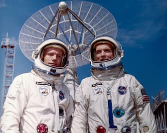 (Original Caption) Cape Kennedy, Florida: Gemini 8 astronauts Neil Armstrong (L) and David Scott pose March 11 in front of one of the giant tracking antennae at the near launch complex 19, from which they will be launched March 15 on a rendezvous and walk-in-space mission.
