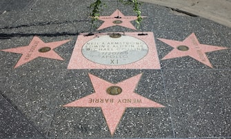 A wreath is placed by a plate dedicated to US astronauts Neil Armstrong, Edwin E. Aldrin and Michael Collins at Hollywood Boulevard in Hollywood, California on August 25,2012.  Neil Armstrong, the first man to walk on the moon in 1969, died on August 25. Armstrong was commander of the Apollo 11 mission that made the first manned lunar landing on July 20, 1969.   AFP PHOTO/JOE KLAMAR        (Photo credit should read JOE KLAMAR/AFP via Getty Images)