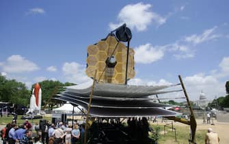 Washington, UNITED STATES: A full scale model of the James Webb Space Telescope sits on the National Mall outside the Smithsonian Air and Space Museum 10 May, 2007 in Washington, DC.  The James Webb Space Telescope  is a planned space infrared observatory, intended to be a significant improvement on the aging Hubble Space Telescope. It will be constructed and operated by NASA with help from ESA and CSA. Formerly called the Next Generation Space Telescope (or NGST), it was renamed after NASA's second administrator, James E. Webb, in 2002. The telescope's launch is planned for no earlier than June 2013. It will be launched on an Ariane 5 rocket.  AFP PHOTO / TIM SLOAN (Photo credit should read TIM SLOAN/AFP via Getty Images)