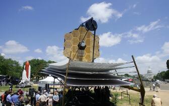 74119848 Washington, UNITED STATES: A full scale model of the James Webb Space Telescope sits on the National Mall outside the Smithsonian Air and Space Museum 10 May, 2007 in Washington, DC. The James Webb Space Telescope is a planned space infrared observatory, intended to be a significant improvement on the aging Hubble Space Telescope. It will be constructed and operated by NASA with help from ESA and CSA. Formerly called the Next Generation Space Telescope (or NGST), it was renamed after NASA's second administrator, James E. Webb, in 2002. The telescope's launch is planned for no earlier than June 2013. It will be launched on an Ariane 5 rocket. AFP PHOTO / TIM SLOAN (Photo credit should read TIM SLOAN/AFP via Getty Images)