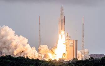 TOPSHOT - Arianespace's Ariane 5 rocket with NASAs James Webb Space Telescope onboard lifts up from the launchpad, at the Europes Spaceport, the Guiana Space Center in Kourou, French Guiana, on December 25, 2021. - The telescope, the most powerful space observatory ever built, is now tentatively set for launch on Christmas Day, after decades of waiting. An engineering marvel, it will help answer fundamental questions about the Universe, peering back in time 13 billion years. (Photo by jody amiet / AFP) (Photo by JODY AMIET/AFP via Getty Images)