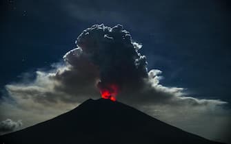 epa06848923 Mount Agung volcano spews hot volcanic ash into the air as seen from Kubu Village in Karangasem, Bali, Indonesia, 29 June 2018. The ash cloud out of Mount Agung was reported to have reached a height of 2000 m after it began to erupt on the evening of 28 June.  The Ngurah Rai International Airport in Bali was shut down at 03.00 am on the 29 June 2018 due to hazards related to the ash cloud.  EPA / MADE NAGI