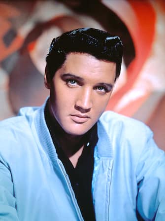 Elvis Presley publicity, head shot, undated photograph. He's wearing a light blue jacket and black shirt.