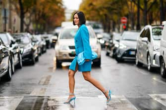 PARIS, FRANCE - OCTOBER 01: Tiffany Hsu wears a blue oversized jacket dress, a blue bag, blue heels shoes, outside Miu Miu, during Paris Fashion Week - Womenswear Spring Summer 2020, on October 01, 2019 in Paris, France. (Photo by Edward Berthelot/Getty Images)