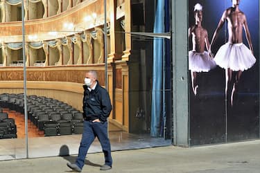 TRENTO, ITALY - MAY 02: A man walking wears a face mask in front of a theater on May 02, 2020 in Trento3, Italy. Italy will remain on lockdown to stem the transmission of the Coronavirus (Covid-19), slowly easing restrictions. (Photo by Alessio Coser/Getty Images)